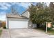 Charming home featuring a spacious two-car garage and well-maintained lawn at 3961 S Uravan St, Aurora, CO 80013