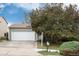 Attractive home showcasing a two-car garage, and well-manicured greenery at 3961 S Uravan St, Aurora, CO 80013