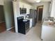 Modern kitchen featuring stainless steel appliances, light countertops, and ample cabinetry at 3961 S Uravan St, Aurora, CO 80013