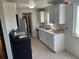 Well-lit kitchen with sleek appliances, white cabinets, and a practical layout at 3961 S Uravan St, Aurora, CO 80013