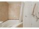 Featuring tile backsplash, this soaking tub has a shower head and white shower curtain at 5800 Tower Rd # 1201, Denver, CO 80249