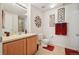 This bathroom offers a single sink, updated fixtures, and decorative wall art for an inviting feel at 5800 Tower Rd # 1201, Denver, CO 80249