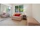 Bright bedroom with an armchair, mirrored closet, and a large window offering natural light at 5800 Tower Rd # 1201, Denver, CO 80249