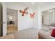 Light-filled bedroom featuring an open layout, butterfly wall art, and mirrored closet doors at 5800 Tower Rd # 1201, Denver, CO 80249