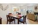 A dining room with a wood table, and access to other rooms in this condo at 5800 Tower Rd # 1201, Denver, CO 80249