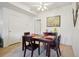 Cozy dining room featuring a wooden table with seating for four and a decorative art piece on the wall at 5800 Tower Rd # 1201, Denver, CO 80249