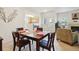 A dining room with a wood table, and access to other rooms in this condo at 5800 Tower Rd # 1201, Denver, CO 80249