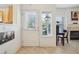 Bright entryway with a front door, a window with blinds, and a view into the living room at 5800 Tower Rd # 1201, Denver, CO 80249