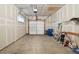 Spacious garage featuring an automatic door, concrete floor, and drywall walls, providing ample storage and parking space at 5800 Tower Rd # 1201, Denver, CO 80249