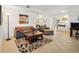 Bright living room featuring an open floor plan connecting to the kitchen at 5800 Tower Rd # 1201, Denver, CO 80249
