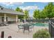 Community pool area with tables and chairs, offering a relaxing and enjoyable space for residents to gather and unwind at 5800 Tower Rd # 1201, Denver, CO 80249