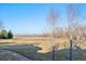 Picturesque backyard view showcasing mature trees and a tranquil lake at 2102 Shoreside Dr, Berthoud, CO 80513