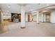 Finished basement area with a bar, neutral carpet, brick accents, and wood doors at 2102 Shoreside Dr, Berthoud, CO 80513