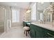 Elegant bathroom featuring double vanity with modern fixtures, a glass-enclosed shower, and bright lighting at 2102 Shoreside Dr, Berthoud, CO 80513