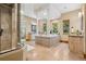 Beautiful primary bathroom featuring a stand alone shower and large tub with pillars at 2102 Shoreside Dr, Berthoud, CO 80513