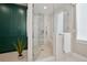 Bright bathroom with a tiled shower, a glass door and a view to teal cabinetry at 2102 Shoreside Dr, Berthoud, CO 80513