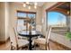 Breakfast nook with a round table, four chairs, and windows overlooking the water at 2102 Shoreside Dr, Berthoud, CO 80513