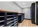 Custom shelving system in closet, featuring black cabinets with blue interior and wood floors at 2102 Shoreside Dr, Berthoud, CO 80513