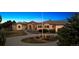 Custom luxury home with mature landscaping, circular driveway, and porte-cochere at 2102 Shoreside Dr, Berthoud, CO 80513