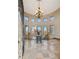Elegant foyer with chandelier, tile flooring, and abundant natural light at 2102 Shoreside Dr, Berthoud, CO 80513