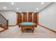 Finished basement game room with a billiard table and custom wood built-in shelving at 2102 Shoreside Dr, Berthoud, CO 80513