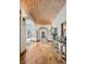 Beautiful hallway with hardwood floors, arched doorways, and brick ceiling at 2102 Shoreside Dr, Berthoud, CO 80513