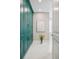 Hallway with full height teal cabinets, white floors, accent art and a plant at 2102 Shoreside Dr, Berthoud, CO 80513