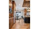Spacious eat-in kitchen featuring wood cabinets, stainless steel appliances, and a black island at 2102 Shoreside Dr, Berthoud, CO 80513