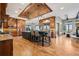 Expansive kitchen with brick ceiling, granite counters, wood cabinets, and a large center island at 2102 Shoreside Dr, Berthoud, CO 80513