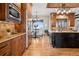 Eat-in kitchen with wood cabinets, stainless steel appliances, granite countertops, and a black island at 2102 Shoreside Dr, Berthoud, CO 80513