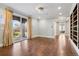 Light-filled living room with hardwood floors, elegant chandelier, and sliding glass doors to the outdoor patio at 2102 Shoreside Dr, Berthoud, CO 80513