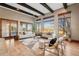 Bright living room featuring hardwood floors, large windows, exposed beams and sliding glass doors at 2102 Shoreside Dr, Berthoud, CO 80513