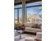 Close up of a naturally lit living room with large windows and neutral decor and beautiful outdoor views at 2102 Shoreside Dr, Berthoud, CO 80513