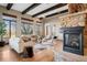 Bright and airy living room with a fireplace, wood beams, and large windows at 2102 Shoreside Dr, Berthoud, CO 80513