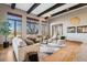 Bright living room with hardwood floors, large windows and exposed wood beams in the ceiling at 2102 Shoreside Dr, Berthoud, CO 80513