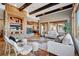 Spacious living room with stone fireplace, wood beams, hardwood floors and large windows for natural light at 2102 Shoreside Dr, Berthoud, CO 80513