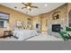 Main bedroom with stone arch fireplace, hardwood floors, neutral walls and lots of natural light at 2102 Shoreside Dr, Berthoud, CO 80513