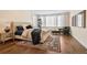 Comfortable main bedroom featuring a tufted headboard, hardwood floors, and plenty of natural light at 2102 Shoreside Dr, Berthoud, CO 80513