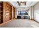 Spacious office featuring custom built-in bookshelves, desk, and scenic mountain views from the large window at 2102 Shoreside Dr, Berthoud, CO 80513