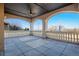 Covered patio with tile floors, white columns, and views of the water at 2102 Shoreside Dr, Berthoud, CO 80513