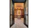 View into a wine cellar with brick floors and a custom storage for wine bottles at 2102 Shoreside Dr, Berthoud, CO 80513