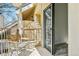 Open balcony with two chairs and sliding glass doors leading to vinyl-floored interior at 4876 E Kentucky Ave # F, Denver, CO 80246