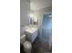 Bright bathroom featuring a single sink vanity and a mirror at 4876 E Kentucky Ave # F, Denver, CO 80246