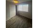 Bedroom featuring ample natural light, hardwood floors, and neutral paint at 4876 E Kentucky Ave # F, Denver, CO 80246