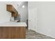 Kitchen area featuring a stainless steel sink, quartz countertops, and modern wood cabinets at 4876 E Kentucky Ave # F, Denver, CO 80246