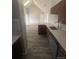 Kitchen space with stainless steel appliances, modern lighting, and an island at 4876 E Kentucky Ave # F, Denver, CO 80246