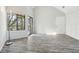 Bright living room with sleek flooring, large windows and sliding door to the outdoor patio at 4876 E Kentucky Ave # F, Denver, CO 80246