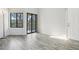 Bright living room with sleek flooring, large windows and sliding door to the outdoor patio at 4876 E Kentucky Ave # F, Denver, CO 80246