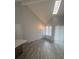 Bright living room with vaulted ceiling, skylight, hardwood floors, and neutral paint at 4876 E Kentucky Ave # F, Denver, CO 80246