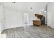 Open living space featuring modern floors, an adjacent kitchen, and white sliding-door closet at 4876 E Kentucky Ave # F, Denver, CO 80246